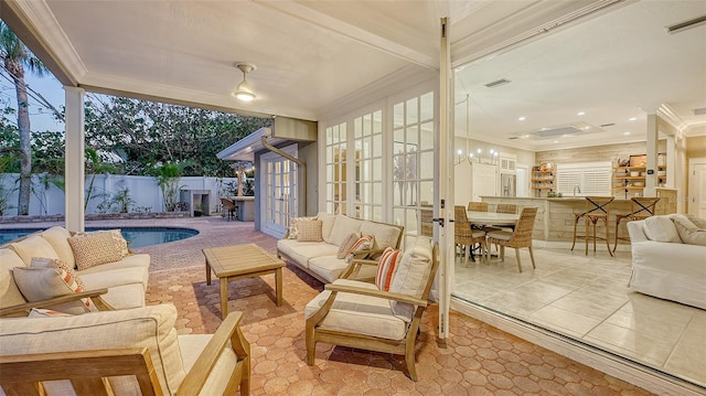 sunroom / solarium with french doors and a pool