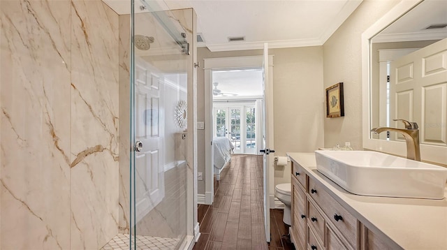 bathroom with vanity, french doors, crown molding, toilet, and wood-type flooring