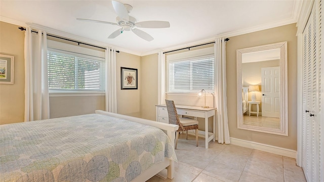 bedroom with ceiling fan, light tile patterned flooring, ornamental molding, and a closet