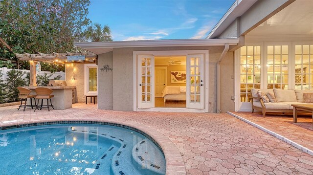 view of pool with a pergola, an outdoor bar, an outdoor hangout area, and a patio area