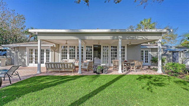 back of property featuring outdoor lounge area, ceiling fan, a patio area, and french doors