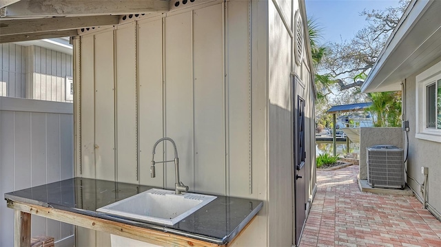 exterior space featuring sink and central AC unit