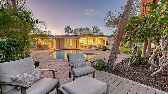 pool at dusk with a patio