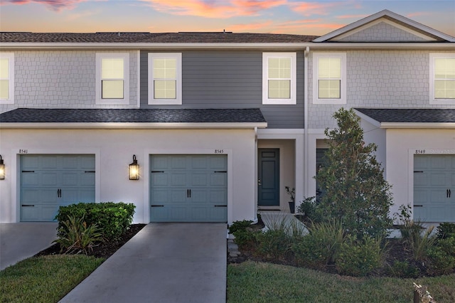 townhome / multi-family property featuring a garage