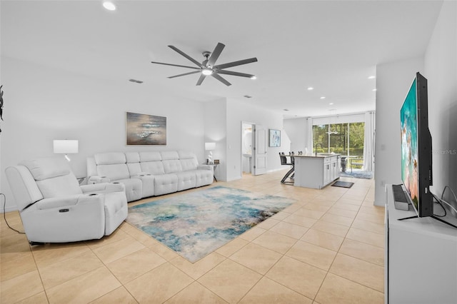 tiled living room featuring ceiling fan and sink