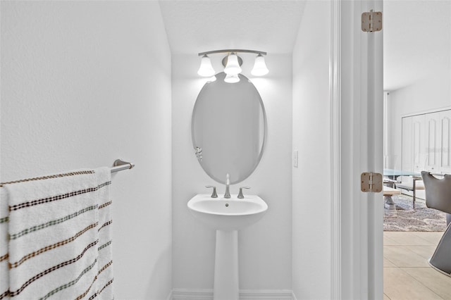 bathroom with tile patterned flooring and a textured ceiling