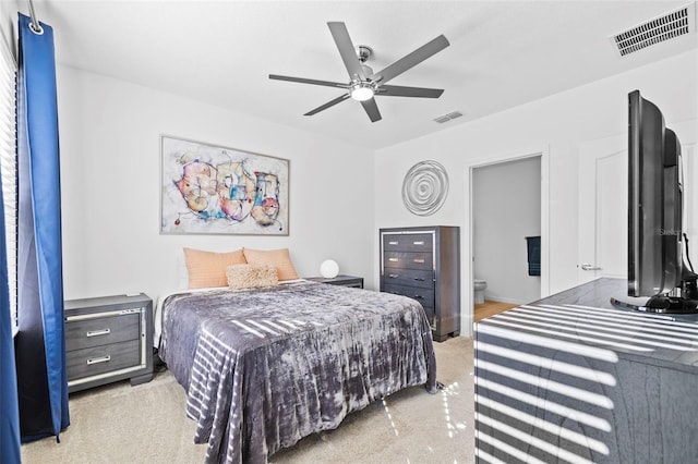 carpeted bedroom featuring connected bathroom and ceiling fan