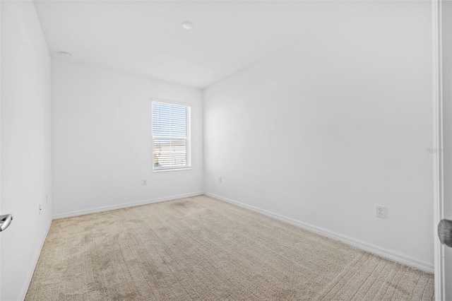 unfurnished room featuring light colored carpet