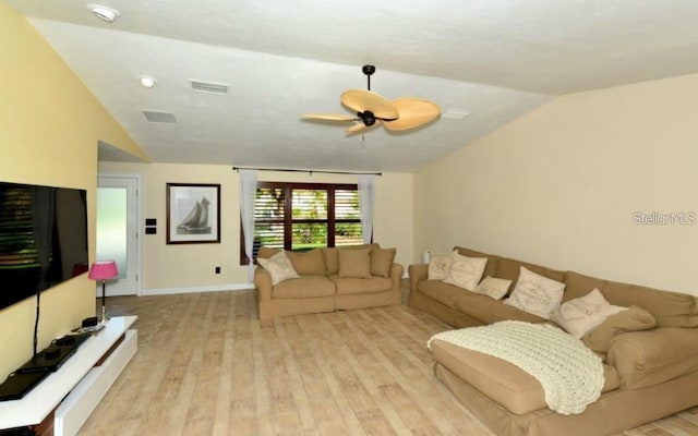 living room featuring ceiling fan, light hardwood / wood-style floors, and lofted ceiling