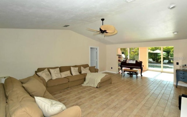 living room featuring light wood-type flooring, vaulted ceiling, and ceiling fan