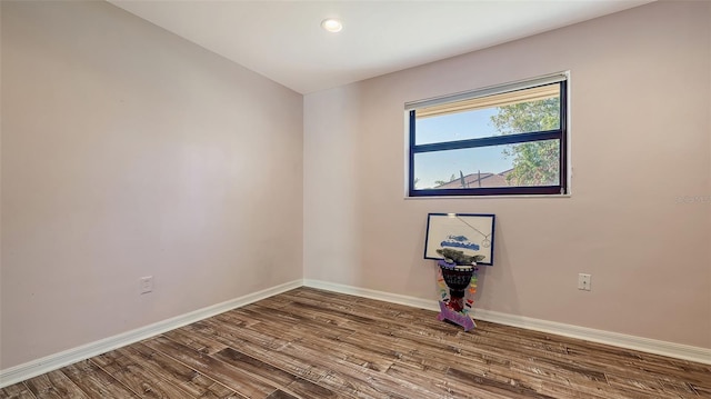 empty room with hardwood / wood-style flooring