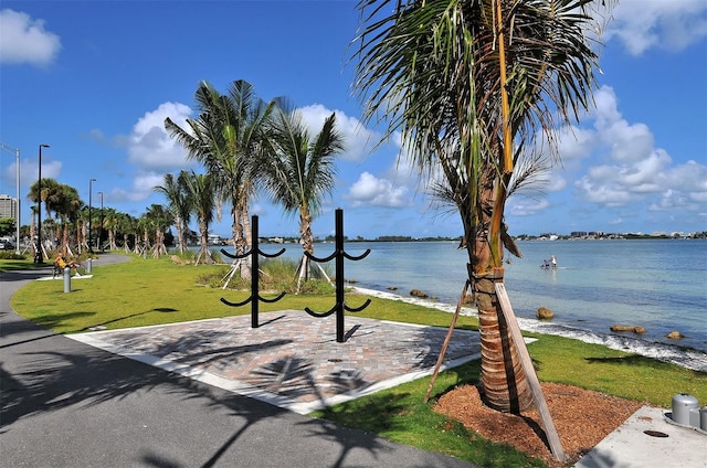 view of community featuring a water view and a yard