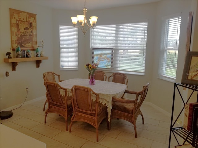 tiled dining area featuring plenty of natural light and a notable chandelier