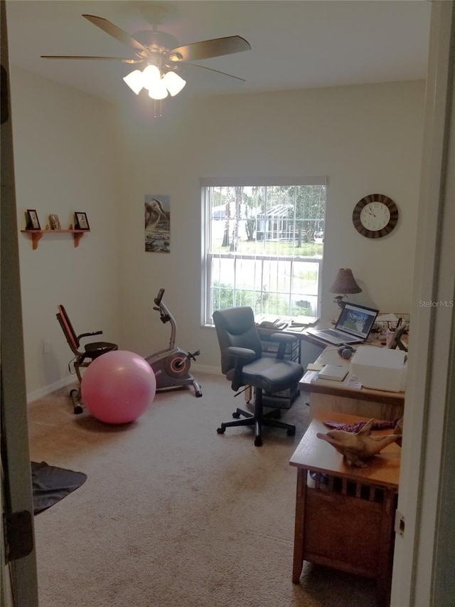 carpeted home office with ceiling fan