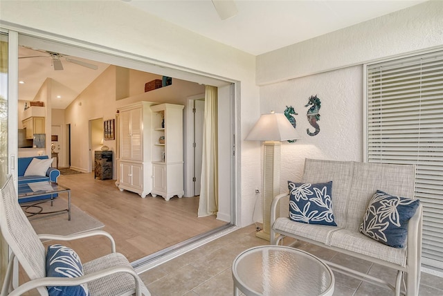 sitting room with wood-type flooring, ceiling fan, and lofted ceiling