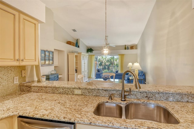 kitchen featuring backsplash, sink, decorative light fixtures, dishwasher, and lofted ceiling