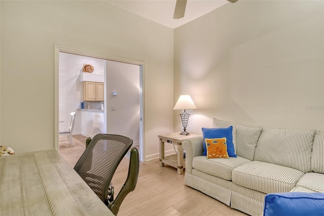 home office with ceiling fan and light hardwood / wood-style flooring