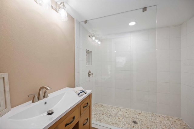 bathroom featuring vanity and a tile shower