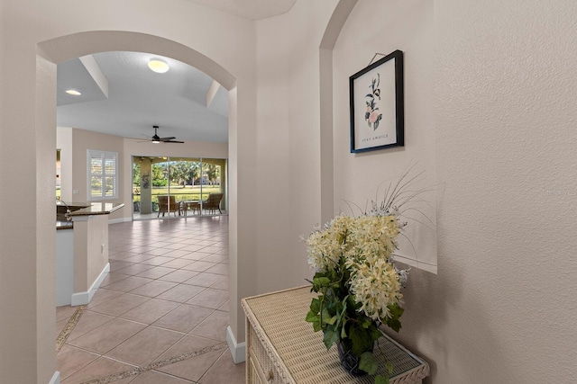 hall with light tile patterned floors