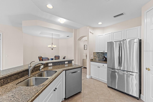 kitchen with white cabinets, dark stone countertops, and appliances with stainless steel finishes