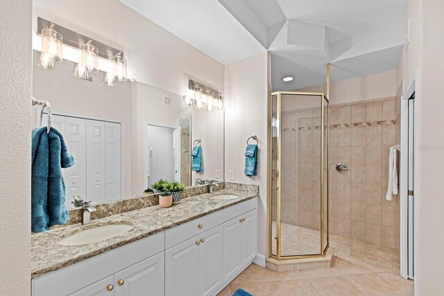 bathroom featuring tile patterned flooring, vanity, and walk in shower