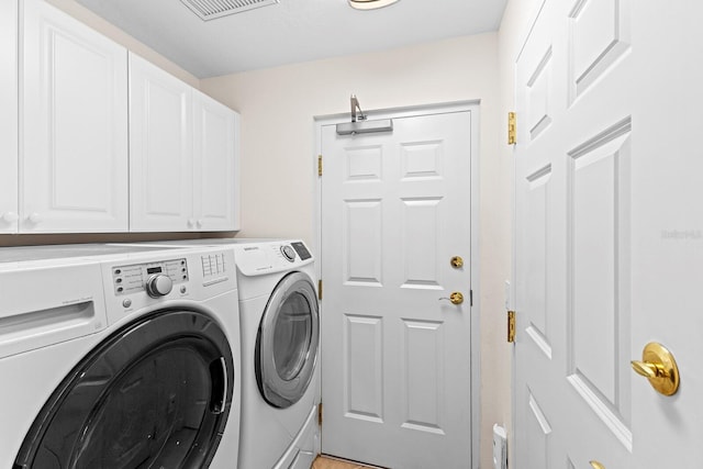 laundry area with cabinets and independent washer and dryer