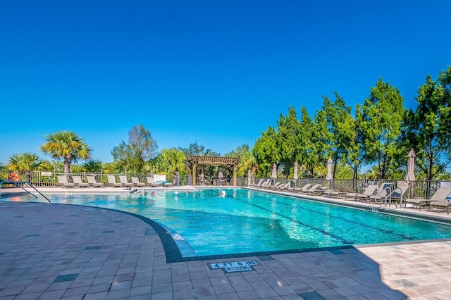 view of swimming pool with a pergola and a patio