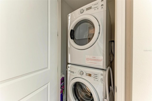 washroom with stacked washer and clothes dryer