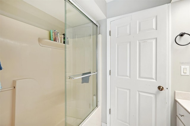 bathroom featuring vanity and combined bath / shower with glass door