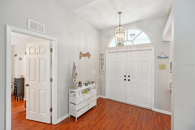 entrance foyer featuring a chandelier and dark hardwood / wood-style floors