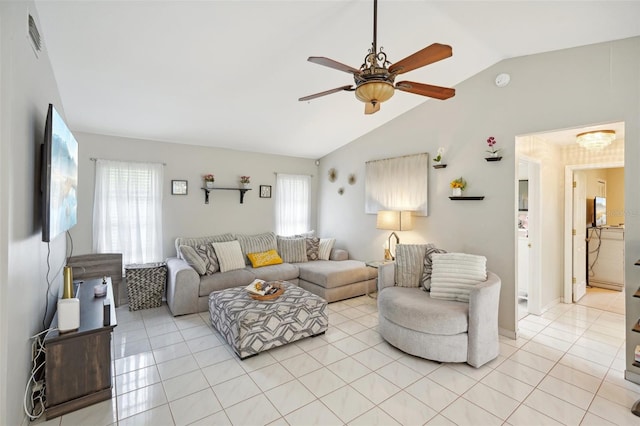 living room with ceiling fan, light tile patterned floors, and lofted ceiling