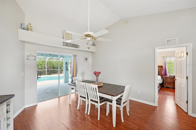 dining room with lofted ceiling, hardwood / wood-style flooring, ceiling fan, and a healthy amount of sunlight