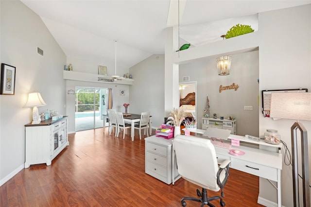 office with dark hardwood / wood-style floors and high vaulted ceiling