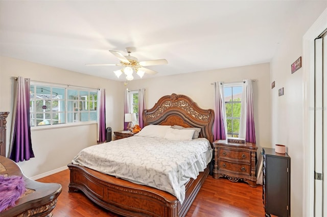 bedroom with ceiling fan and dark hardwood / wood-style floors