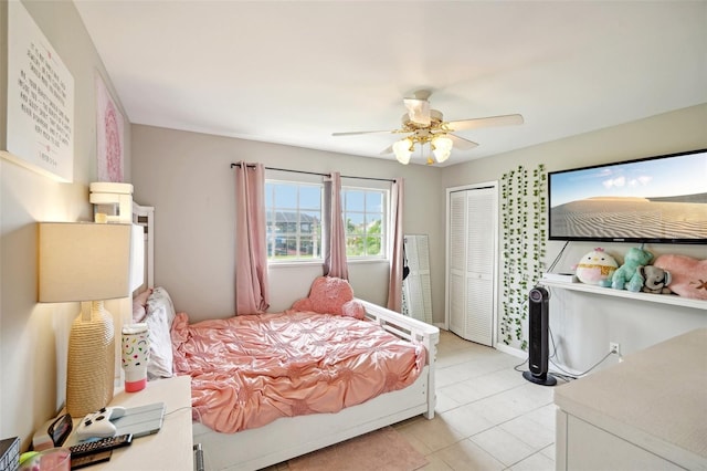 bedroom with ceiling fan and light tile patterned floors