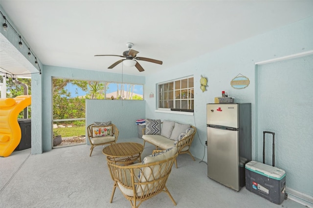 living area with ceiling fan