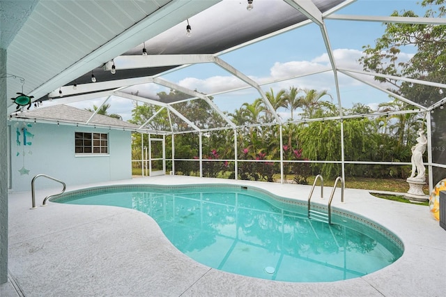 view of swimming pool with a lanai and a patio area