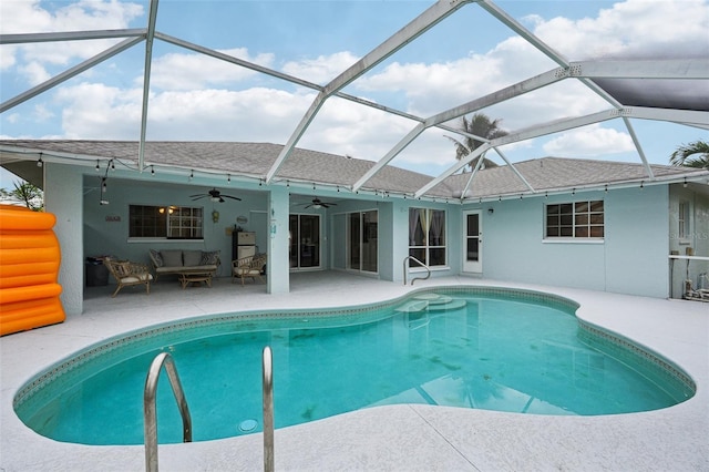 view of pool featuring outdoor lounge area, glass enclosure, ceiling fan, and a patio area