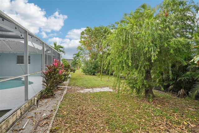 view of yard featuring glass enclosure