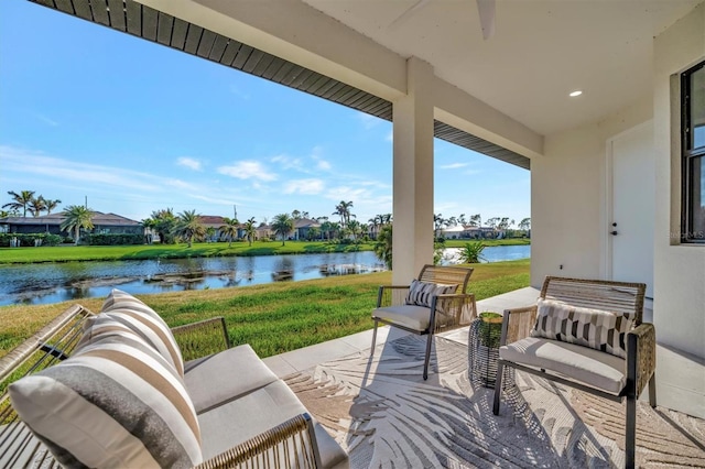 view of patio with an outdoor living space and a water view