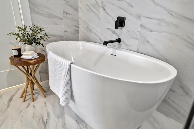 bathroom with tile walls and a bathing tub