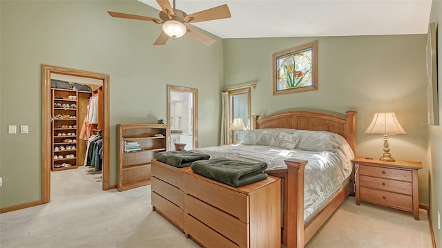 carpeted bedroom with a closet, high vaulted ceiling, and ceiling fan