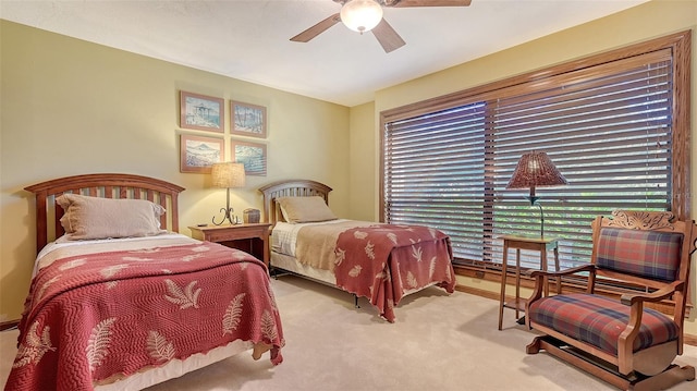 bedroom featuring light carpet and ceiling fan