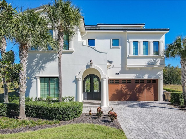 view of front facade featuring a garage and french doors