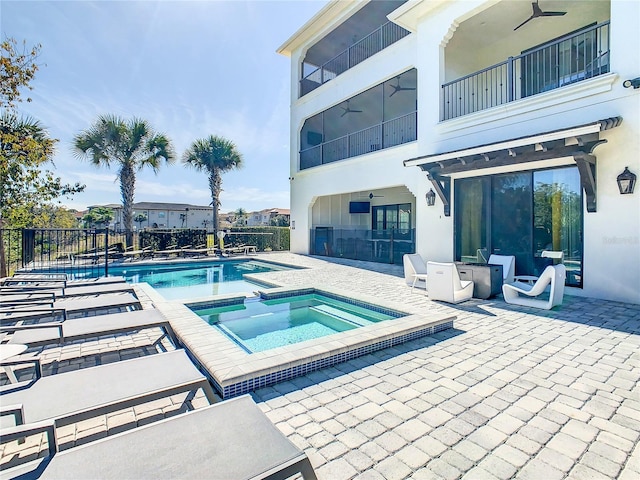 view of swimming pool featuring a patio area and an in ground hot tub