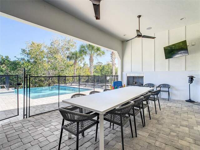 view of patio featuring a fenced in pool and ceiling fan