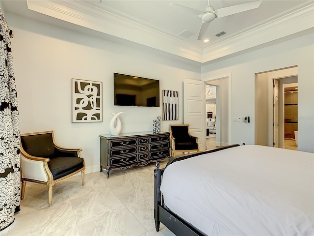 bedroom with ceiling fan, ensuite bath, crown molding, and a tray ceiling