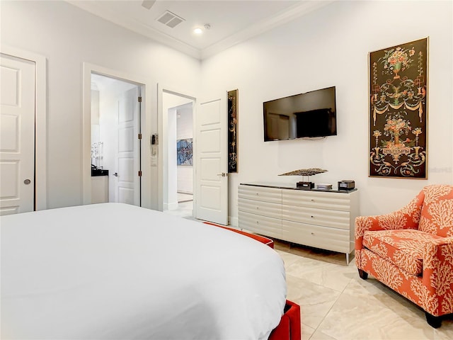 bedroom featuring ornamental molding and ensuite bath