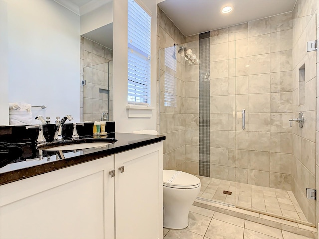 bathroom with toilet, vanity, tile patterned floors, and an enclosed shower