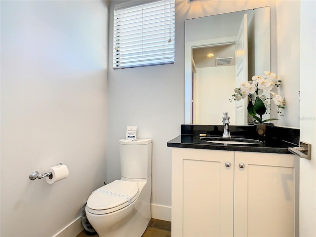 bathroom featuring vanity and toilet